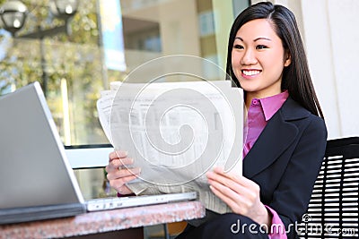 Asian Business Woman Reading Newspaper Stock Photo