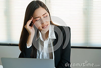 Asian business woman stressful working with a computer for a long time, Office syndrome concept. Stock Photo