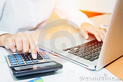 Asian Business woman using a calculator to calculate Stock Photo
