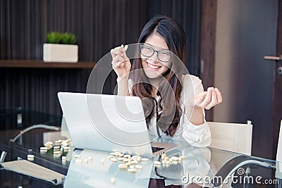 An Asian business woman using drugs while working Stock Photo