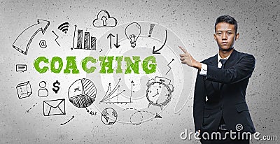 Asian Businessman Pointing `Coaching` Text Sketch Concept Stock Photo