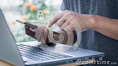 Asian businessman using the smart mobile phone to access on phone with laptop for validate password Stock Photo