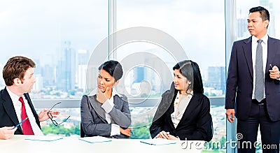 Asian Businesspeople in office team meeting Stock Photo