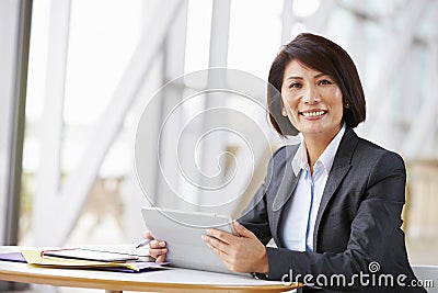 Asian businesswoman with digital tablet, smiling to camera Stock Photo