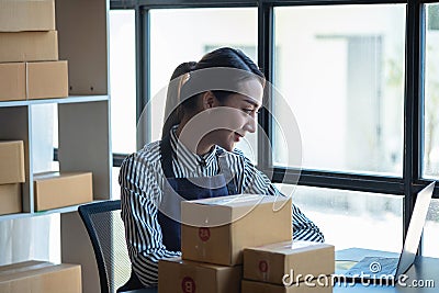 An Asian businesswoman enjoys his online SME business selling products, profiting from opening an online store, and taking orders Stock Photo