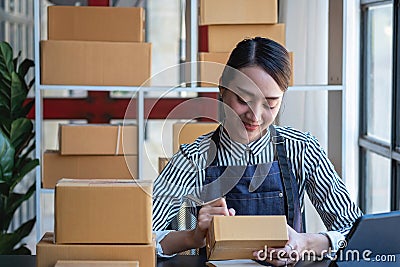 An Asian businesswoman enjoys his online SME business selling products, profiting from opening an online store, and taking orders Stock Photo