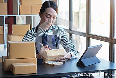 An Asian businesswoman enjoys his online SME business selling products, profiting from opening an online store, and taking orders Stock Photo