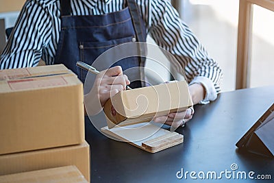 An Asian businesswoman enjoys his online SME business selling products, profiting from opening an online store, and taking orders Stock Photo