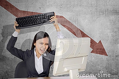 Asian businesswoman feeling depressed looking global economic impact report on the computer Stock Photo