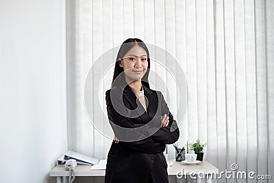 Asian businesswoman. stand happy smile Proud of business success the office Stock Photo