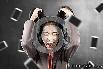 Asian businesswoman stress with a falling smartphone Stock Photo