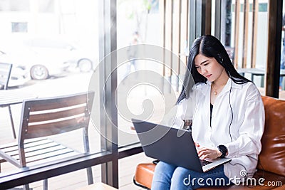 Asian businesswomen are using notebook computers and wear headphones for online meetings and working from home Stock Photo