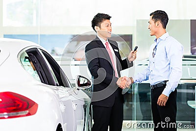 Asian Car Salesman selling auto Stock Photo