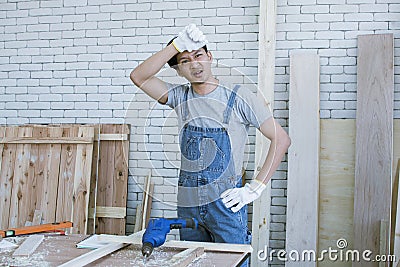 Carpenter is getting tired after producing furniture Stock Photo