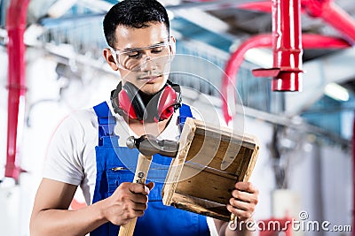 Asian Carpenter in wood workshop working Stock Photo