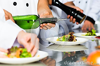 Asian Chef in restaurant kitchen cooking Stock Photo