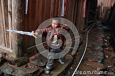 Asian child boy villager about 5 years old, playing outdoors Editorial Stock Photo