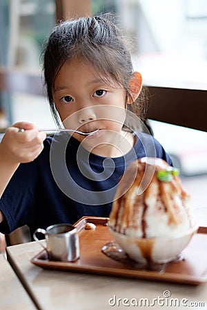 Asian Child Enjoys Eating Hawaiian Shave Ice Frozen Dessert Stock Photo