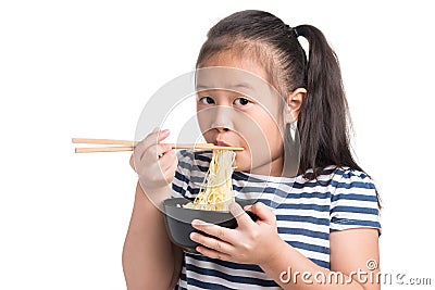 Asian child girl age 7 year , eating Instant noodles on white b Stock Photo