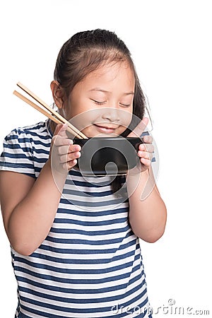 Asian child girl age 7 year , eating Instant noodles on white b Stock Photo