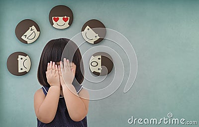 Asian child girl with green concrete wall background, Feelings and emotions of kid Stock Photo