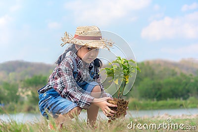Asian Child girl plant sapling tree in the nature spring for reduce global warming growth feature Stock Photo