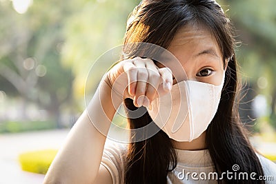 Asian child girl wearing protective medical mask,people with dirty hands,wash hands thoroughly before touching,rubbing the eyes, Stock Photo