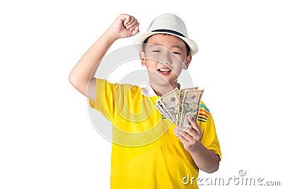 Asian child holding money while standing isolated on white background Stock Photo