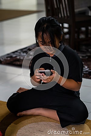 Asian child little girl playing game on mobile phone. Communication concept Stock Photo