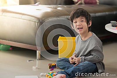 Asian child playing with colorful construction blocks Stock Photo