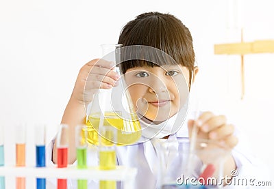 Asian child playing scientist with colorful lab tubes Stock Photo