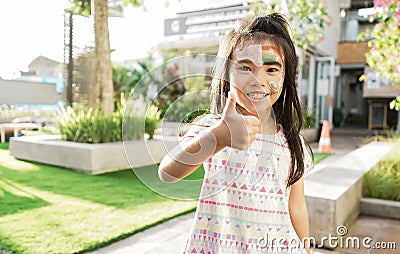 asian Child preschooler with face painting. Make up. Stock Photo