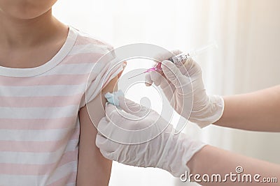 Asian child receiving injection or vaccine Stock Photo