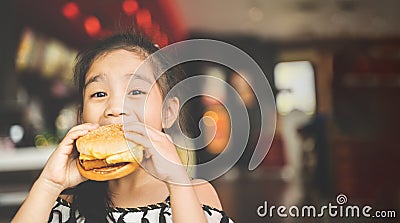 Asian Children eat chicken cheese Hamburger Food Court Stock Photo