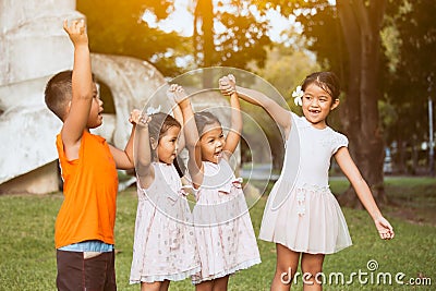 Asian children holding hand and raise their hand Stock Photo