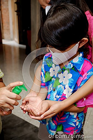 Asian children using liquid gel hand sanitizer Stock Photo