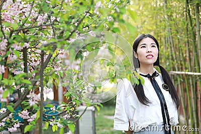 Asian Chinese Happy young cute adorable lovely student youth in a park garden outdoor in summer Stock Photo