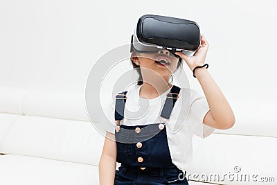 Asian Chinese little girl experiencing virtual reality at home Stock Photo