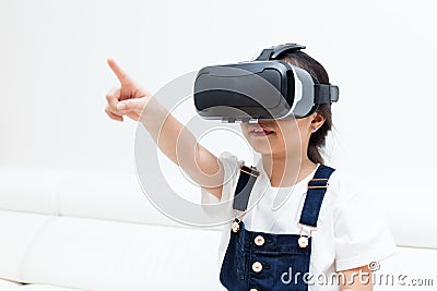 Asian Chinese little girl experiencing virtual reality at home Stock Photo