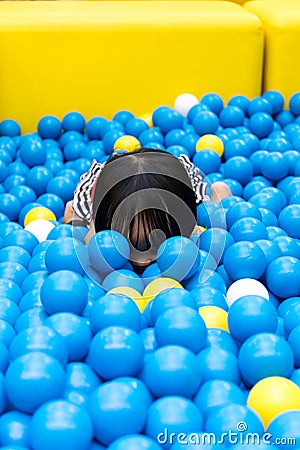 Asian Chinese Little Girl Hiding At Balls Pool Stock Photo
