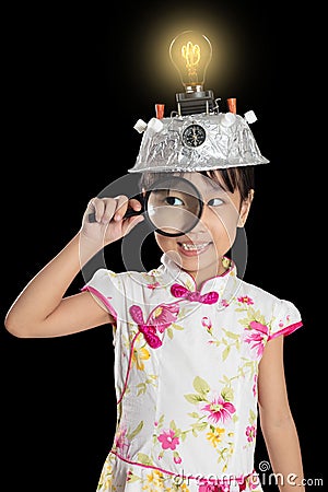 Asian chinese little girl holding magnifier with virtual reality Stock Photo
