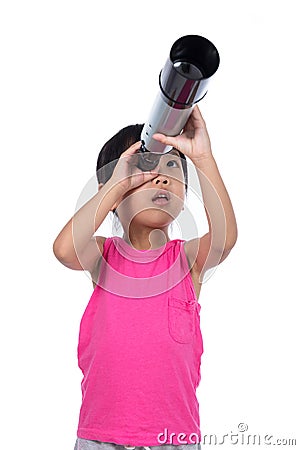 Asian Chinese little girl looking through a telescope Stock Photo