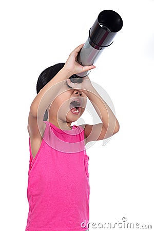 Asian Chinese little girl looking through a telescope Stock Photo