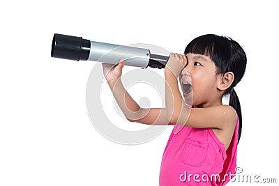 Asian Chinese little girl looking through a telescope Stock Photo