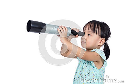 Asian Chinese little girl looking through a telescope Stock Photo