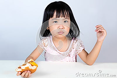 Asian Chinese little girl Refusing Eating Burger Stock Photo