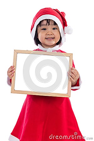 Asian Chinese little girl in santa costume holding blank message Stock Photo