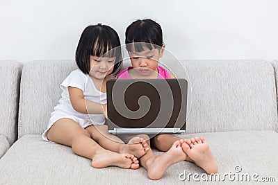 Asian Chinese little sisters playing computer Stock Photo