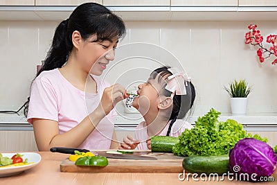 Asian Chinese mother and daughter making salad together Stock Photo