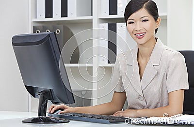 Asian Chinese Woman & Computer in Office Stock Photo
